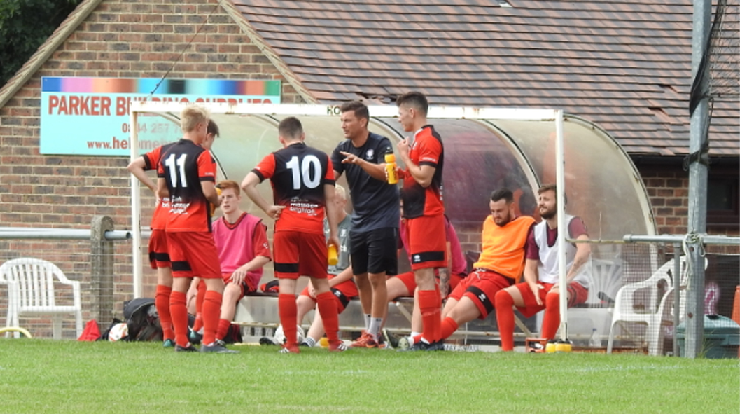 Hassocks manager Mark Dalgleish gives out instructions from the dugout
