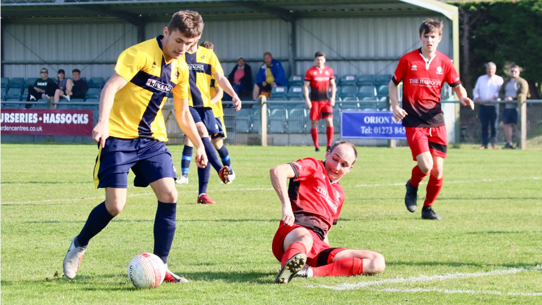 Andy Whittingham puts in a sliding tackle for Hassocks against Eastbourne Town