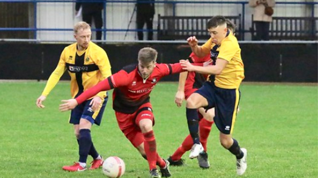 Alex Spinks on the ball for Hassocks against Eastbourne Town