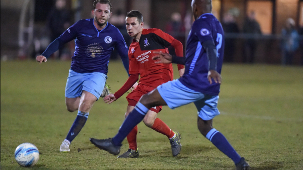 James Westlake of Hassocks threads a pass through against Crowborough Athletic