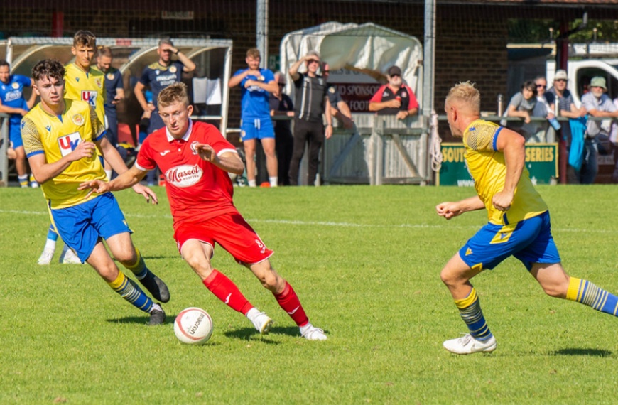 Josh Short runs with the ball for Hassocks against Eastbourne Town