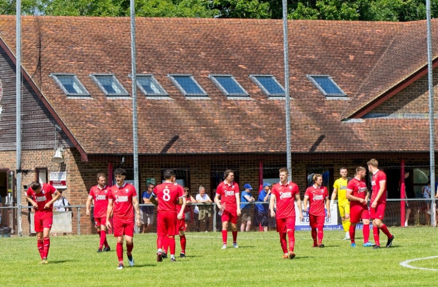 Hassocks players enter the pitch from the Clubhouse at the Beacon