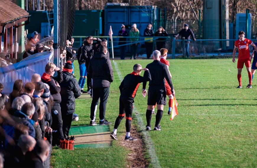 The dugouts at the Beacon with a busy crowd watching Hassocks take on Steyning Town on Boxing Day 2022