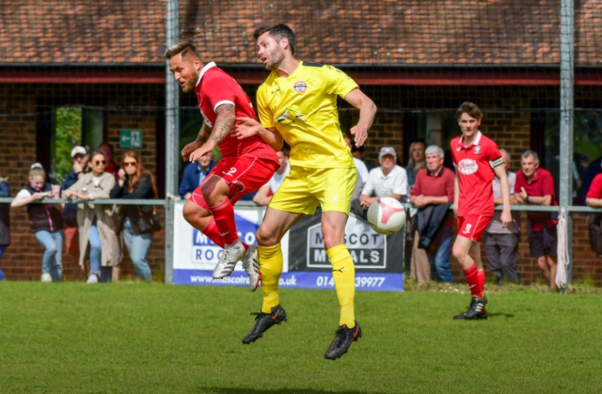 Bradley Bant challenges for a header as Hassocks play Crawley Down Gatwick