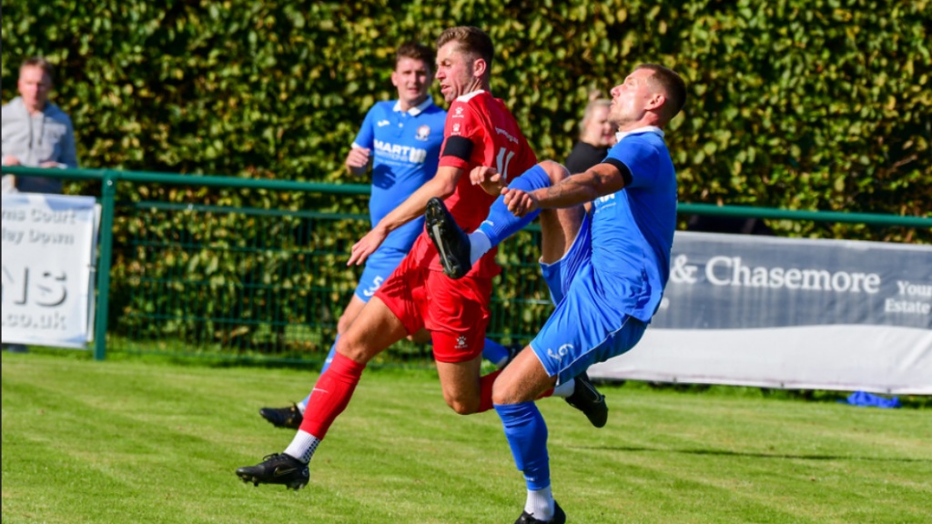 Alex Bygraves controls a ball in the sky for Hassocks against Crawley Down Gatwick