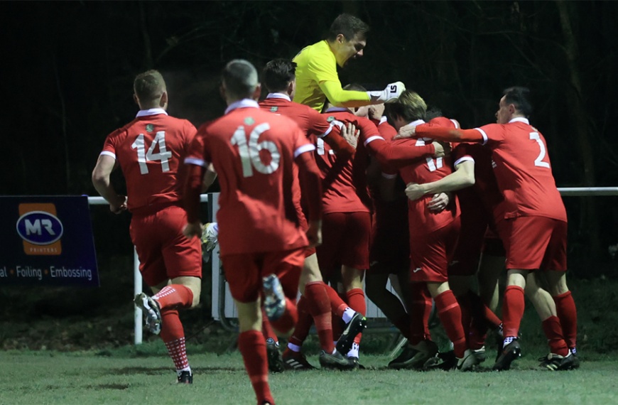 Hassocks players celebrate their last minute winner in a 2-1 victory away at Roffey in February 2023