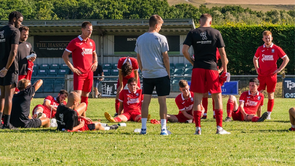 Hassocks players are given a team talk following their 3-1 FA Cup defeat to Uxbridge