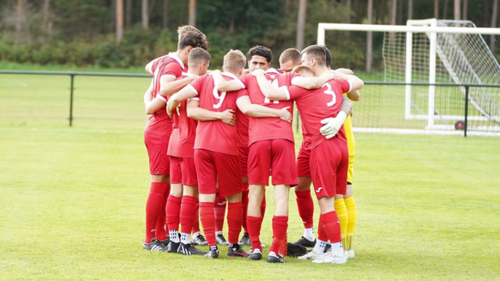 Hassocks players in a huddle before their Southern Combination Premier Division game at Loxwood in October 2022