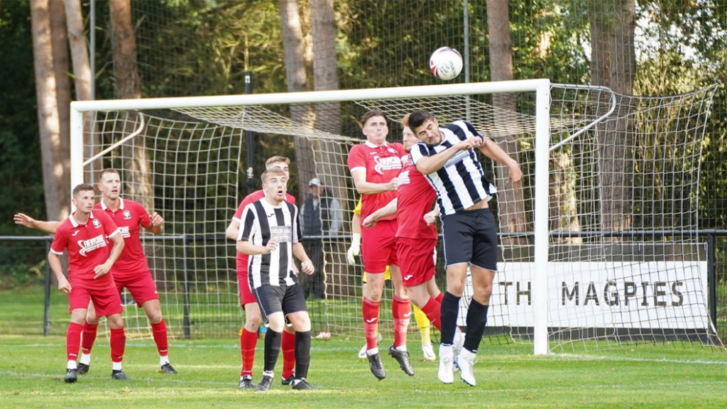 Hassocks defend a long throw against Loxwood at the Nest in October 2022
