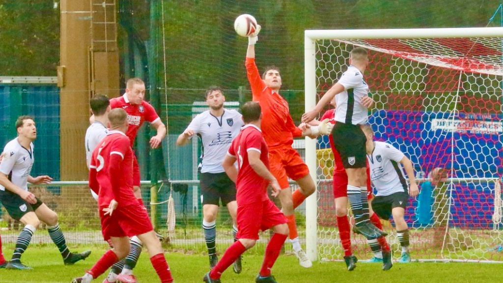 The Bexhill United goalkeeper is called into action against Hassocks