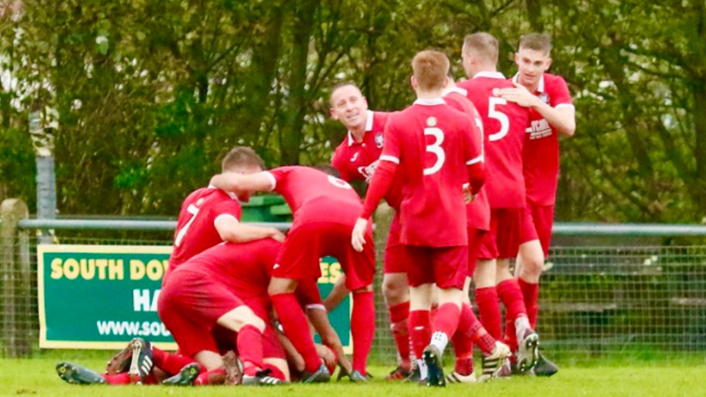 Hassocks players celebrate a goal against Bexhill United
