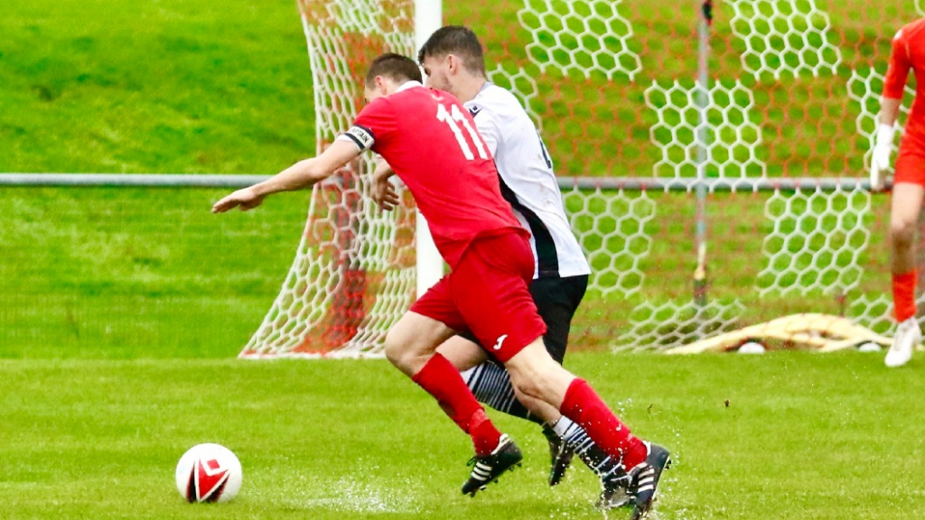 Jack Troak runs with the ball for Hassocks against Bexhill United