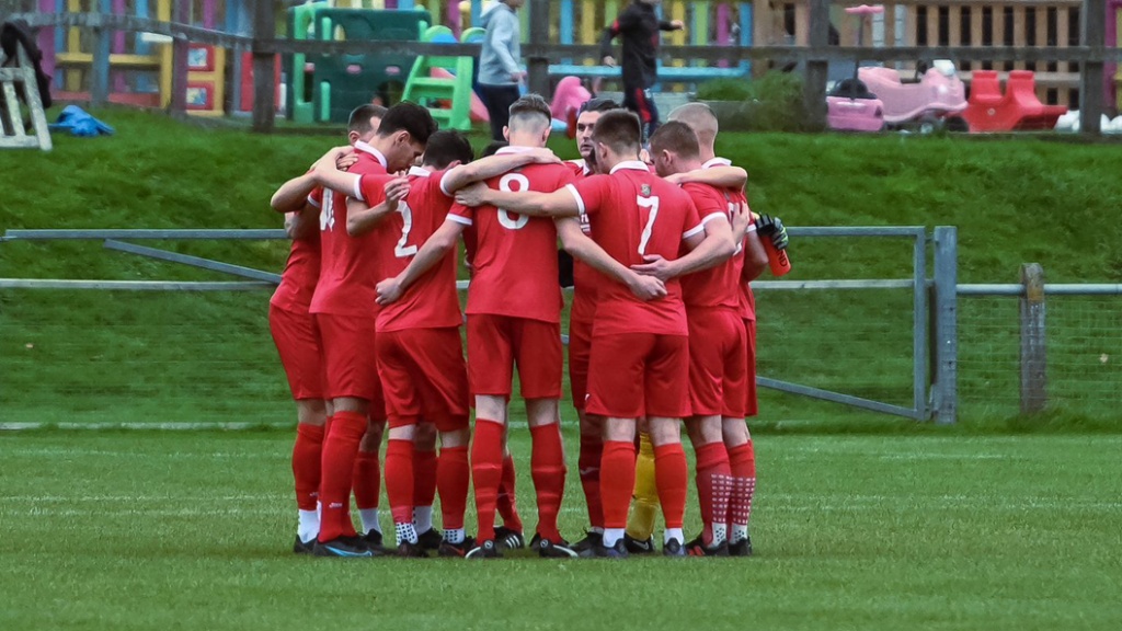 Hassocks players in a huddle before their Southern Combination League Premier Division match with Saltdean United