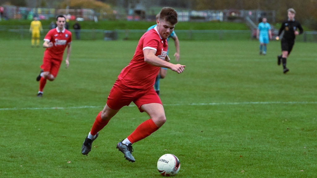 Hassocks midfielder JJ Minty on the ball against Saltdean United
