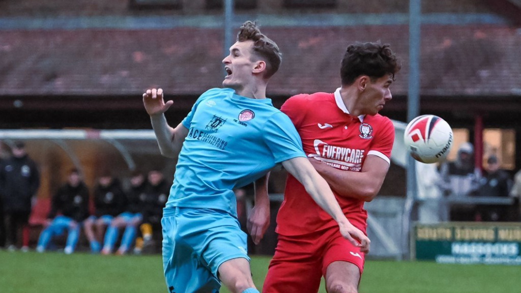 Hassocks striker Liam Benson challenges against Saltdean United