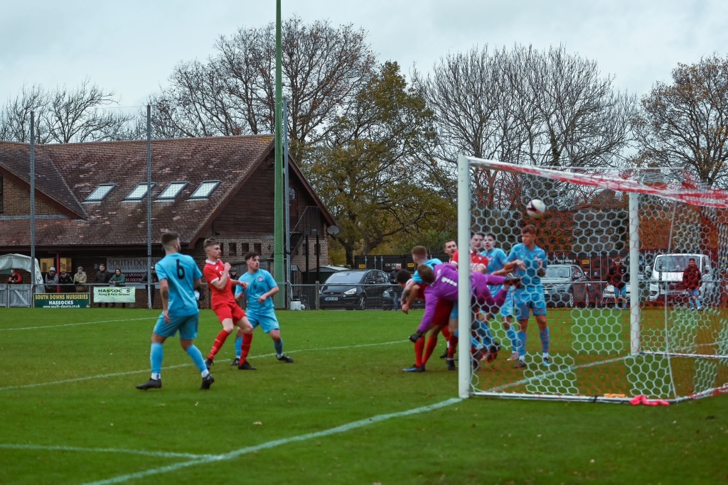 A goalmouth scramble in the game between Hassocks and Saltdean United