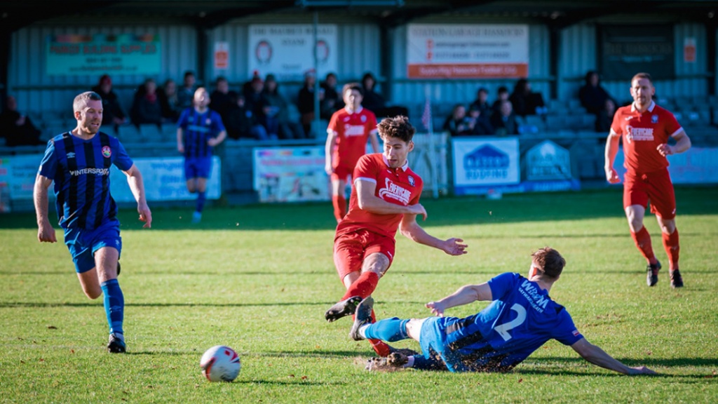Liam Benson shoots for Hassocks against Steyning Town