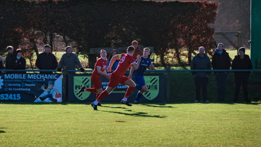 The Hassocks defence chase back against a Steyning opponent
