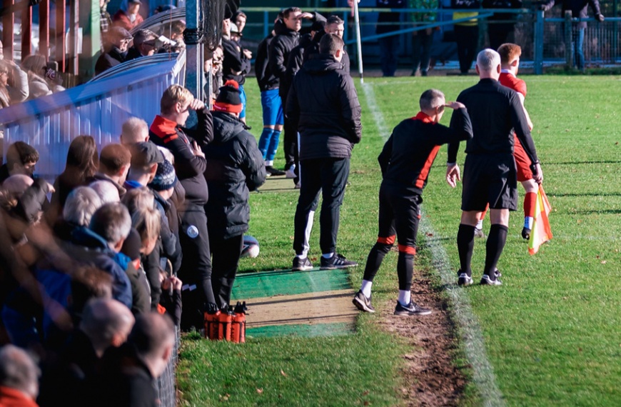 Hassocks head coach James Westlake directs his players in front of a packed Beacon