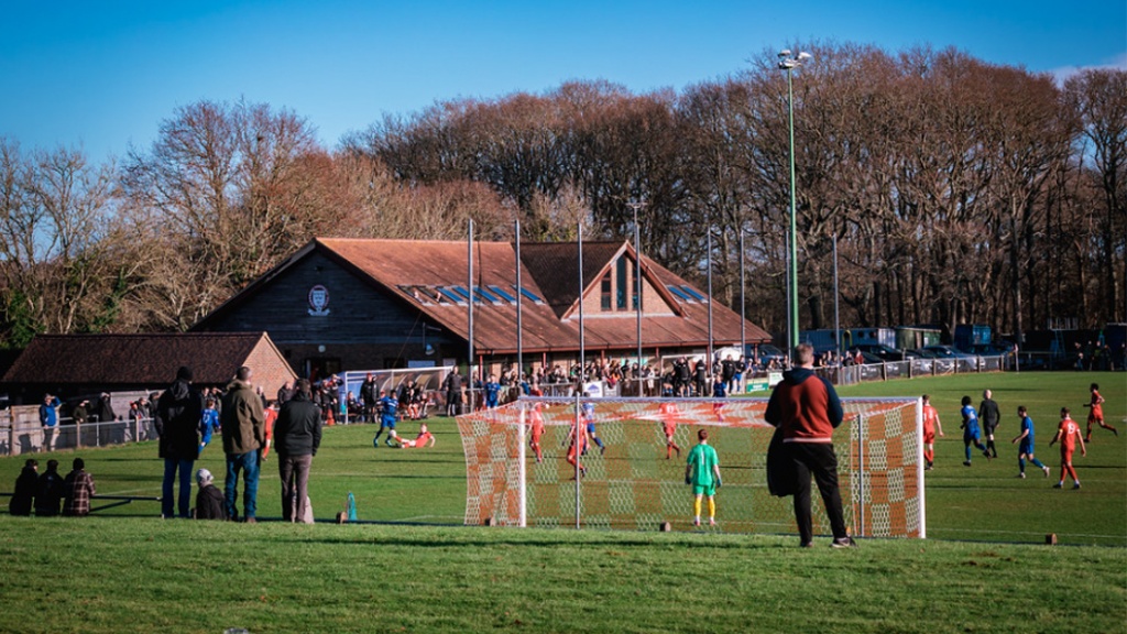 Fans watch on from the bank as Hassocks host Steyning Town at the Beacon