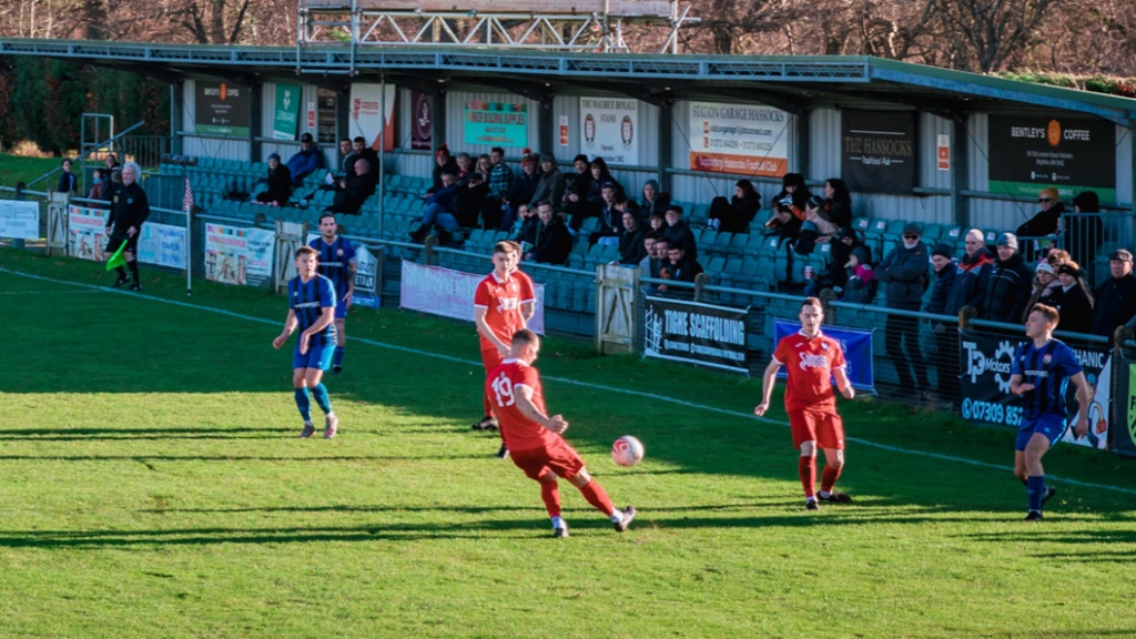 Alex Bygraves clears for Hassocks  against Steyning Town