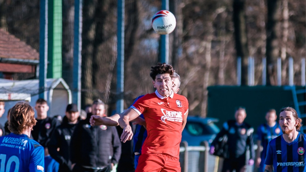 Hassocks forward Liam Benson in action  against Steyning Town