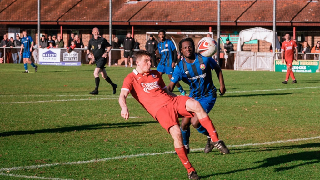 Jack Troak clears for Hassocks against Steyning Town