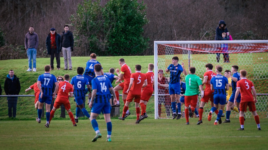 Hassocks goalkeeper Will Broomfield goes up for a corner in last minute against Steyning Town