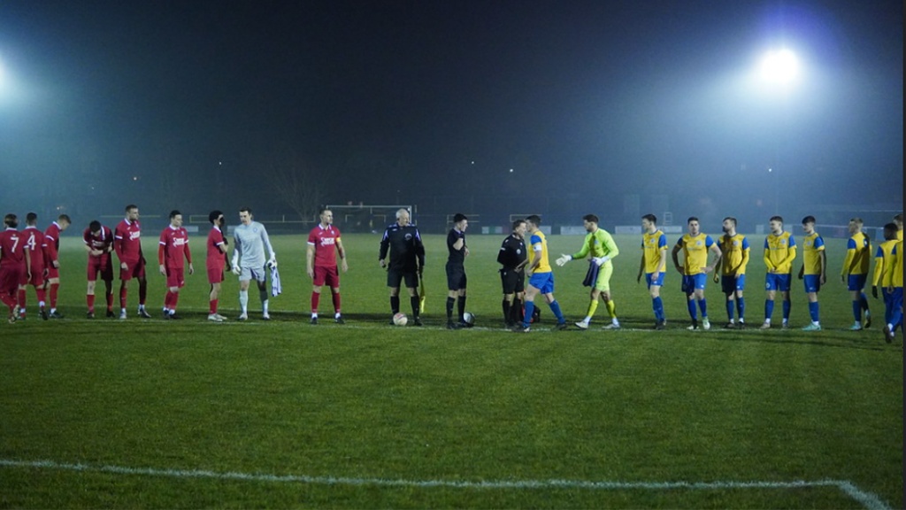 Hassocks and Eastbourne Town players line up before their Southern Combination League Premier Division match at the Saffrons