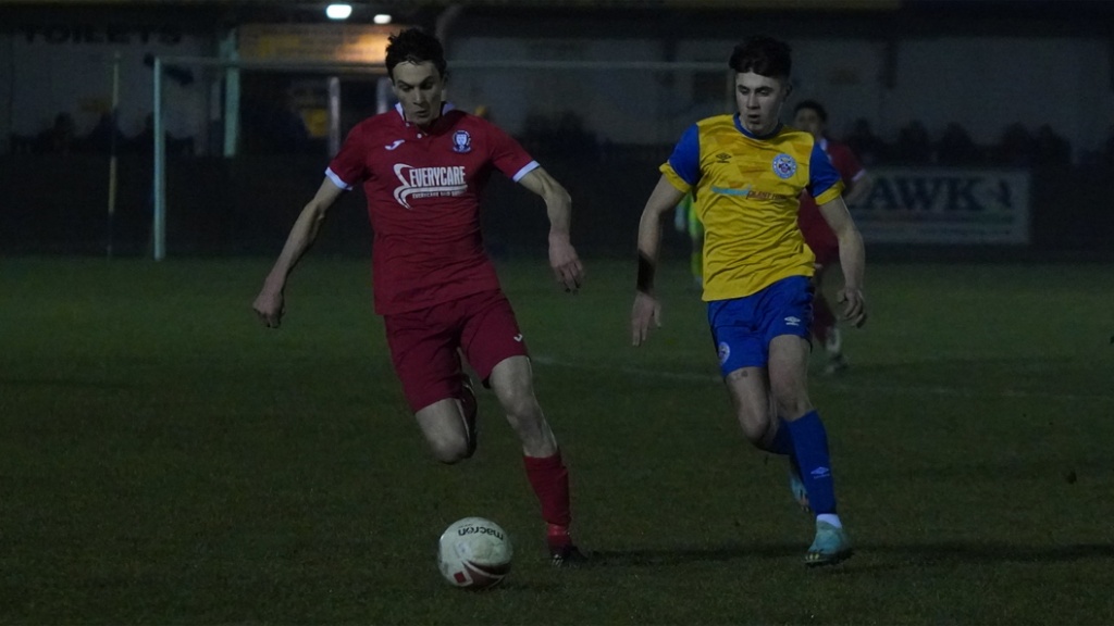 Jack Troak on the ball for Hassocks against Eastbourne Town