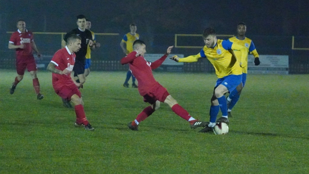 Mike Williamson puts in a tackle for Hassocks against Eastbourne Town