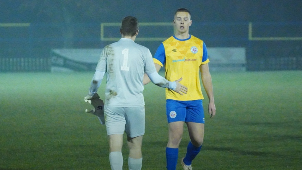 Hassocks goalkeeper James Shaw shakes hands with a Eastbourne Town player