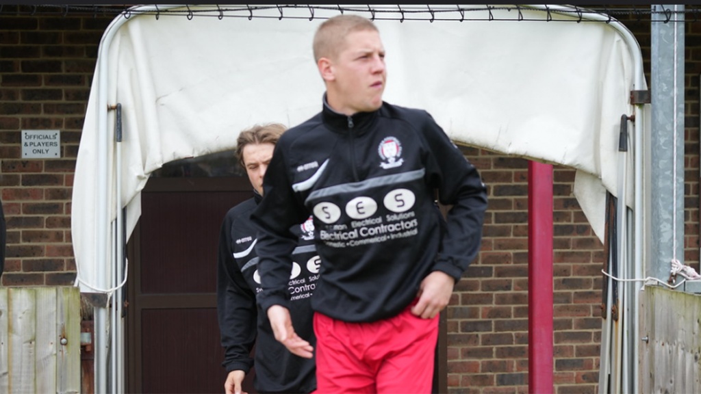 Hassocks midfielder Sam Rogers comes out to warm up