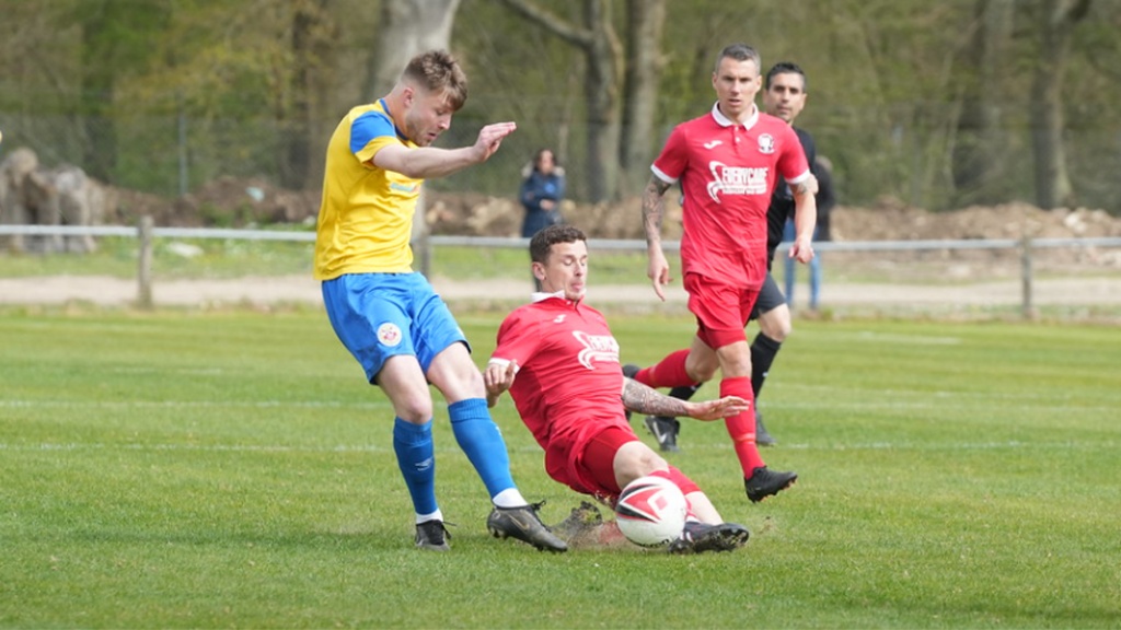 Mike Williamson makes a tackle for Hassocks against Eastbourne Town
