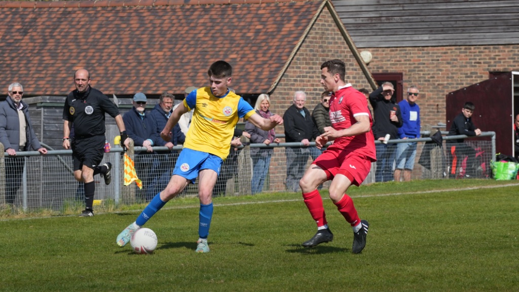 Mike Williamson defends for Hassocks against Eastbourne Town