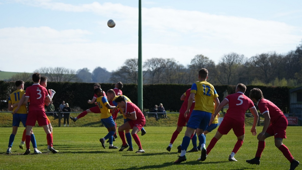 Hassocks defend a ball into their box against Eastbourne Town