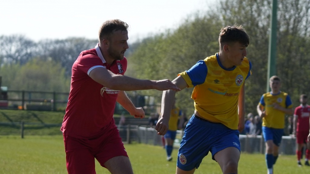 Sam Smith defends for Hassocks against Eastbourne Town