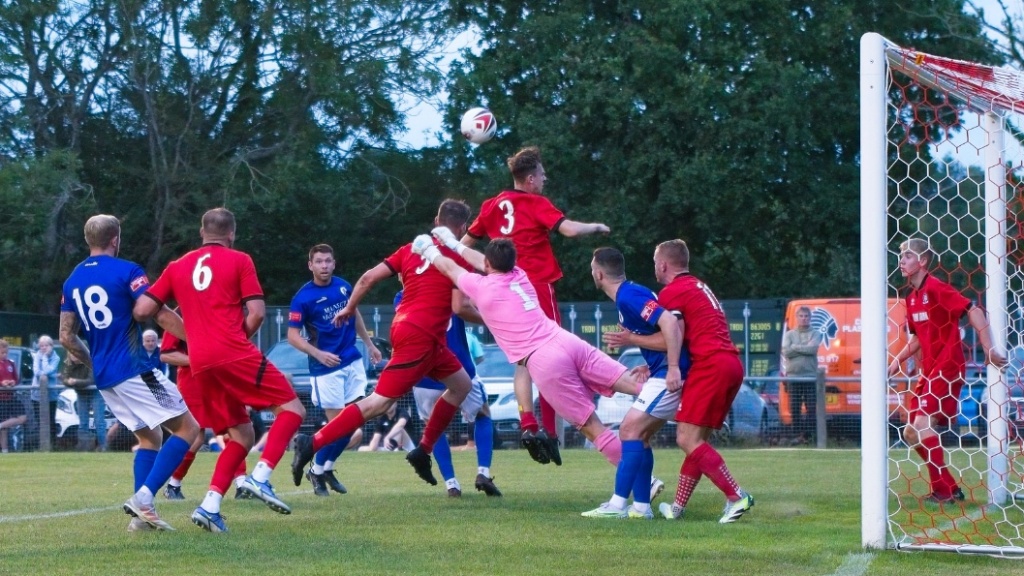 Fraser Trigwell makes a flying save for Hassocks against Burgess Hill Town