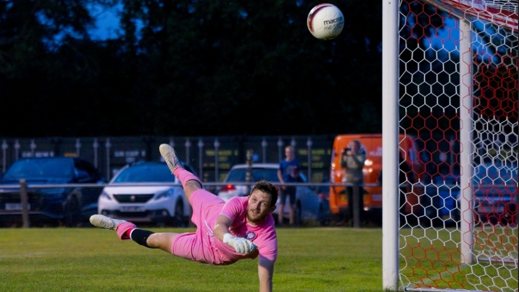 Fraser Trigwell makes a save for Hassocks against Burgess Hill Town
