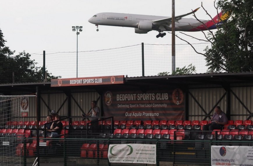 A plane landing over Bedfont Sports Recreation Ground