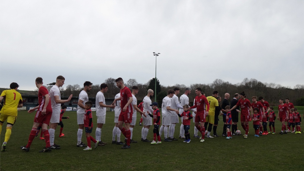 Hassocks and Eastbourne United line up before their Southern Combination Premier Division clash in March 2024