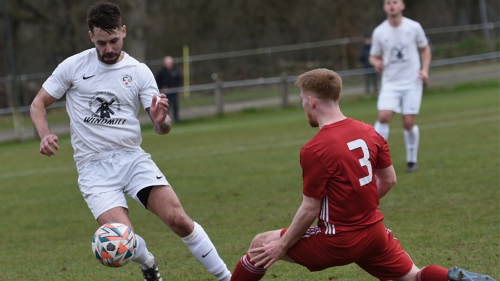 Joe Bull makes a tackle for Hassocks against Eastbourne United