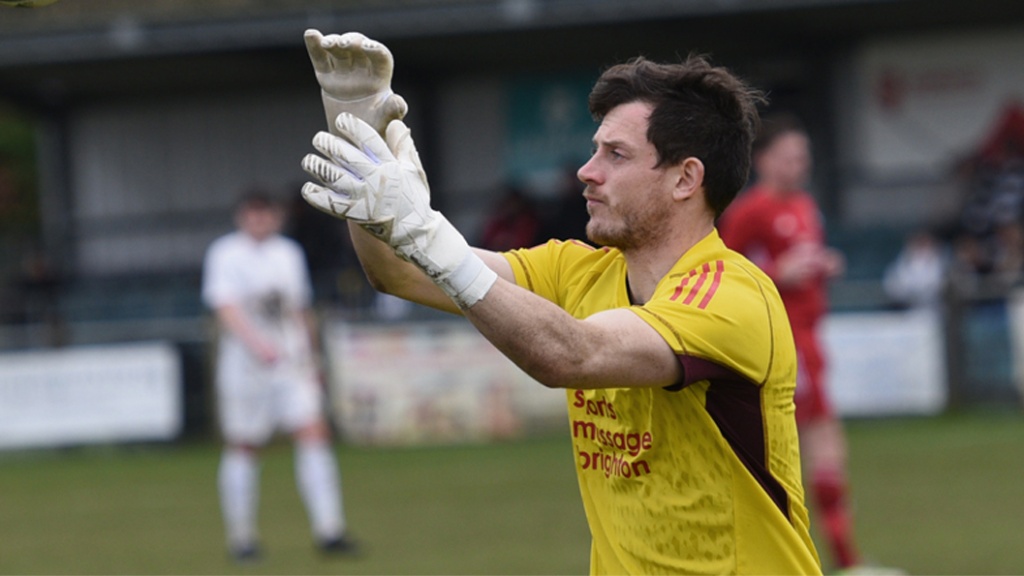 Hassocks goalkeeper Fraser Trigwell collects the ball against Eastbourne United