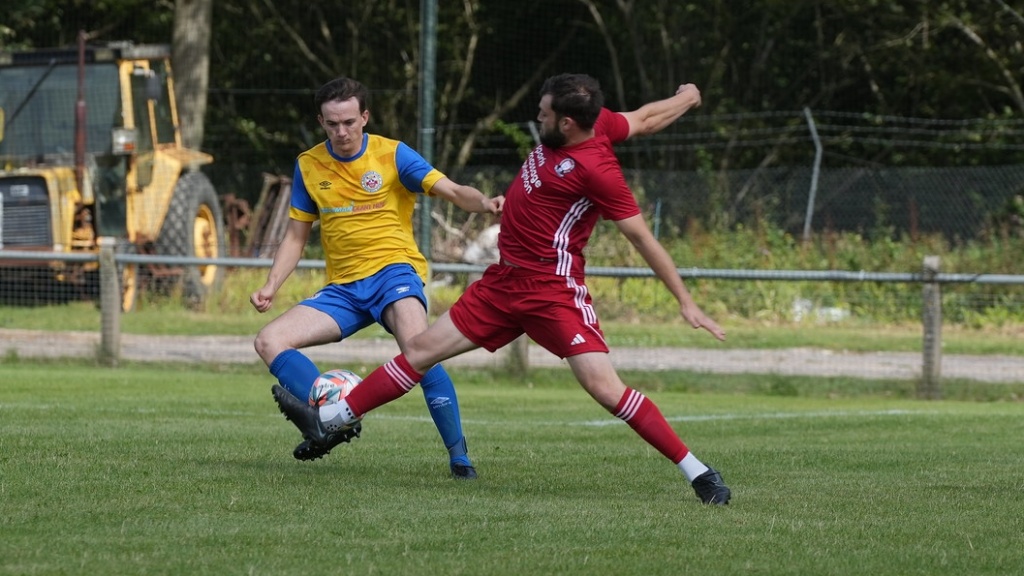 Tom Frankland makes a tackle for Hassocks against Eastbourne Town