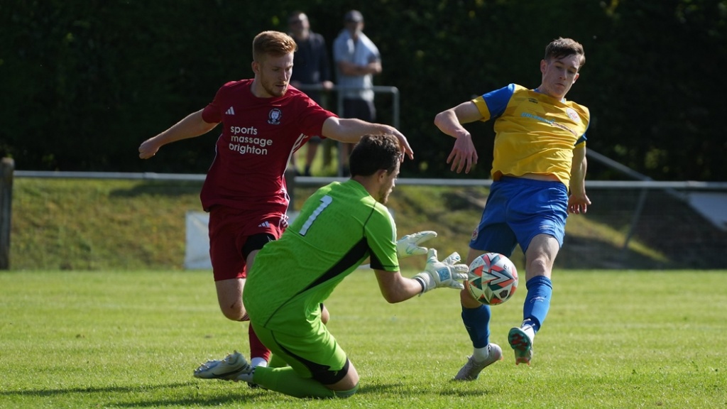 Fraser Trigwell gathers a ball for Hassocks against Eastbourne Town