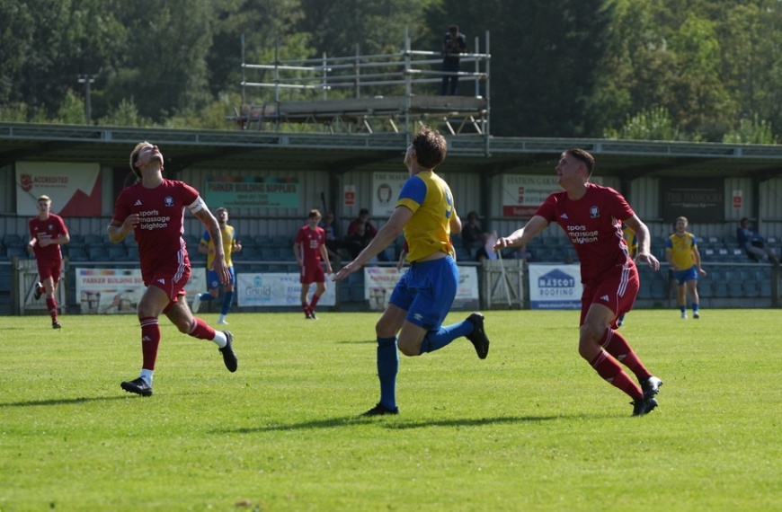 Alex Bygraves and Bradley Tighe deal with a long ball over the top for Hassocks against Eastbourne Town