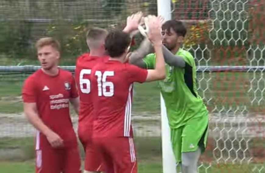 Hassocks players celebrate Jordan Brown saving a penalty in their 3-1 win over Petersfield Town