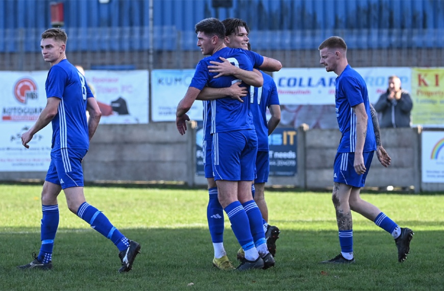 Hassocks celebrate their opening goal away at Camberley in the FA Vase